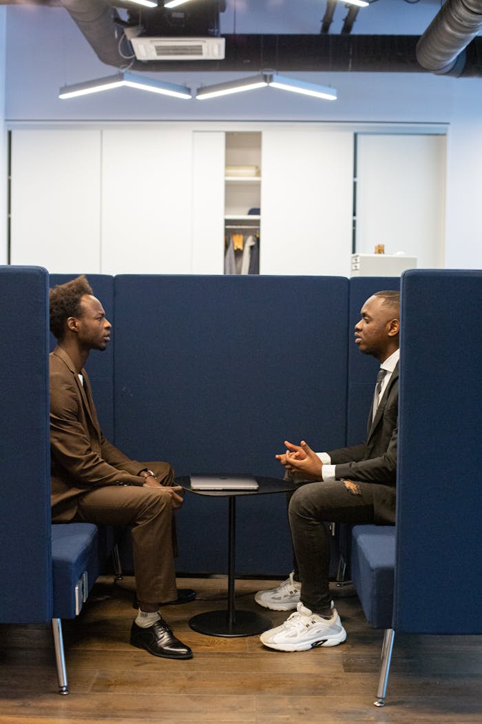 Two professionals in a modern office setting discussing business strategies.